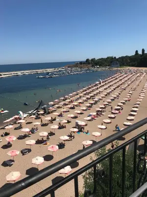 a beach with many umbrellas and people on it at Villa Maria 2 in Chernomorets
