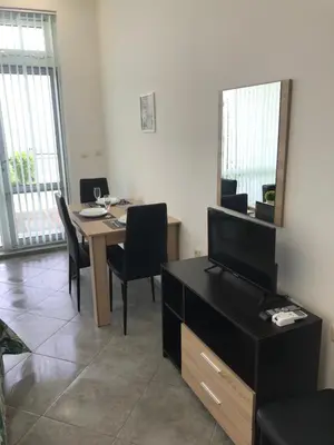 a dining room with a table with chairs and a mirror at Villa Maria 2 in Chernomorets