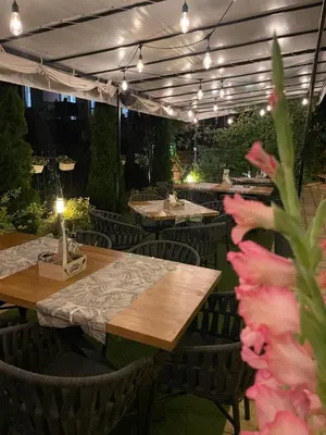 a restaurant with tables and chairs and lights at Family Hotel Saga in Ravda