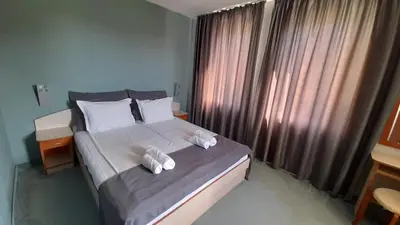 a bedroom with a bed with two towels on it at Family Hotel Saga in Ravda