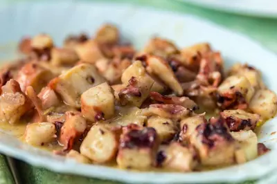 a plate of food with potatoes and raisins at Hotel Tropics & Venera - Ultra All Inclusive in Sveti Vlas