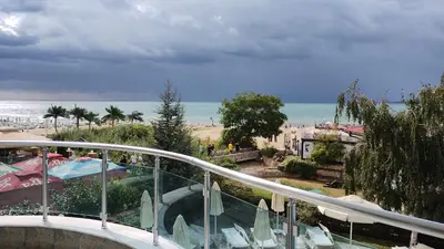 a balcony with a view of a beach and the ocean at Blue Bay Hotel in Sunny Beach