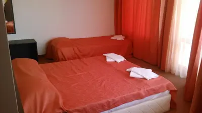 two beds in a hotel room with towels on them at Hotel Bellisimo in Lozenets