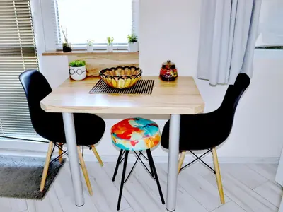 a dining room table with two chairs and a bowl on it at Venum in Varna City