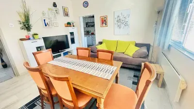 a dining room with a table and chairs and a couch at Venum in Varna City
