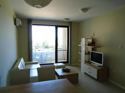 a living room with a couch and a television at Nedev's Apartments in Kavatsi Area in Sozopol