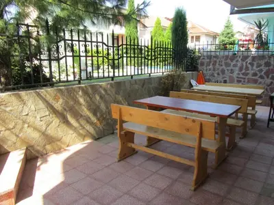 a group of benches and tables on a patio at House Sofia in Sveti Vlas