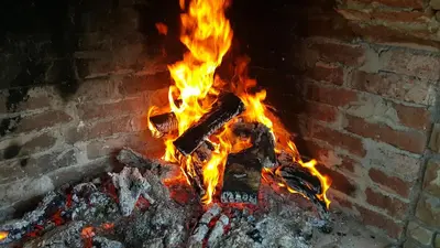 a fire in a brick oven with flames at Complex Strandzhata in Burgas City