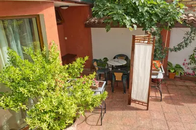 a patio with a table and chairs and plants at House Prodanovi in Sozopol