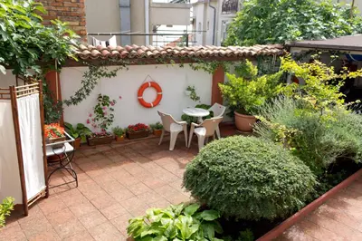 a patio with a table and chairs and plants at House Prodanovi in Sozopol
