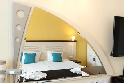a bedroom with a bed with a large mirror at Hotel Evridika in Nesebar