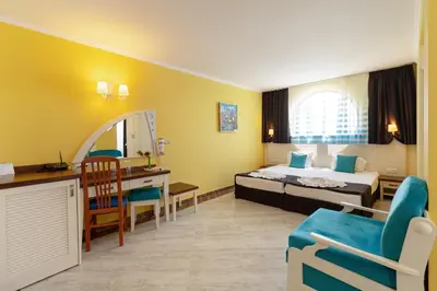 a hotel room with a bed and a desk at Hotel Evridika in Nesebar