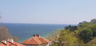 a view of a house with the ocean in the background at Hotel Mida in Obzor