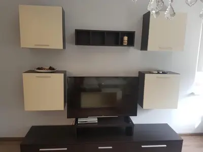 a flat screen tv sitting on top of a black table at Odessus in Varna City