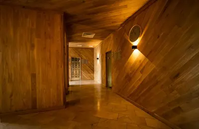 a hallway with wood paneled walls and a door at Wave Resort - Ultra All Inclusive in Pomorie
