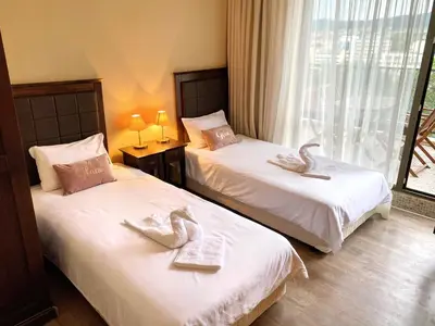 two beds in a hotel room with swans on them at Royal Beach Premium in Sunny Beach