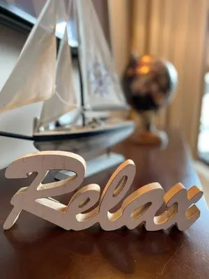 a table with a wooden number and a model boat at Royal Beach Premium in Sunny Beach