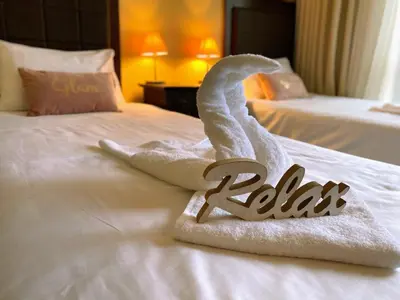 a hotel room with two towels on a bed at Royal Beach Premium in Sunny Beach
