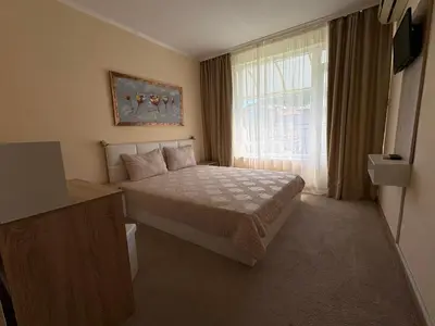 a small bedroom with a bed and a window at Guest house Marina in Obzor