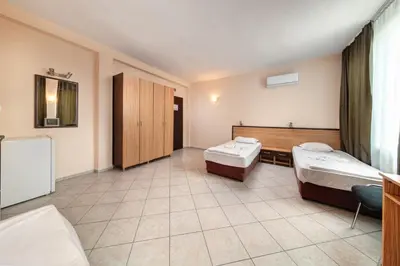 a hospital room with two beds and a desk at Hotel Varly Bryag in Burgas City