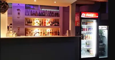 a bar with a lot of bottles of alcohol at Aparthotel Anixi in Obzor