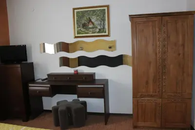 a room with a desk and a wooden cabinet at Guest House Dara in Tsarevo