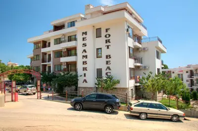 two cars parked in front of a hotel at Messambria Beach Apartments in Sveti Vlas
