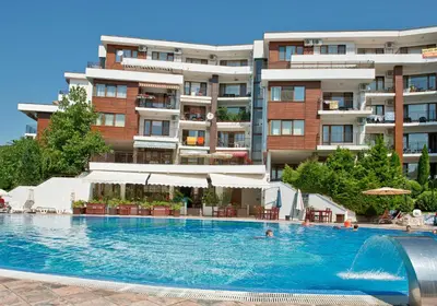 a large swimming pool in front of a building at Messambria Beach Apartments in Sveti Vlas