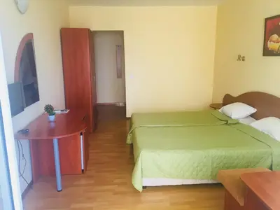 a small room with two beds and a table at Hotel Elmaz in Lozenets