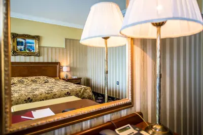 a hotel room with a bed and a mirror at Hotel Palace Marina Dinevi in Sveti Vlas