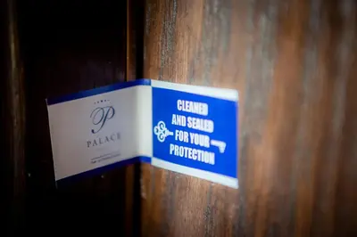 a blue and white sign on a wooden wall at Hotel Palace Marina Dinevi in Sveti Vlas