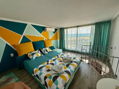 a bedroom with a bed and a colorful wall at Vista Sul Mare in Burgas City