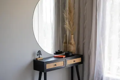 a dressing table with a mirror and a window at Dion Apartments in Lozenets