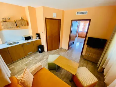 a living room with a couch and a kitchen at Family Hotel Saint Nikola in Nesebar