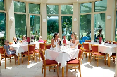 a group of people sitting at tables in a restaurant at Jeravi Beach Hotel - All Inclusive in Sunny Beach