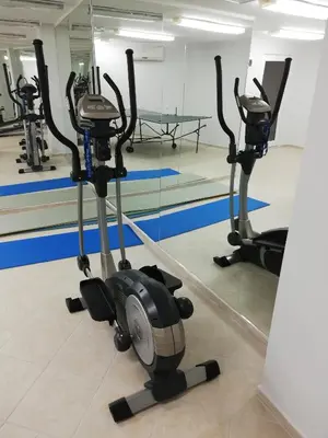 a gym with three exercise bikes in a room at Galateya Sveti Vlas Bułgaria in Sveti Vlas