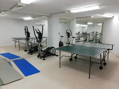 a gym with a ping pong table and exercise equipment at Galateya Sveti Vlas Bułgaria in Sveti Vlas