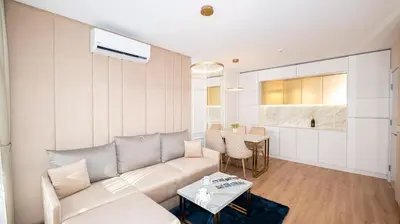 a living room with a couch and a table at Harmony Suites Grand Resort in Sunny Beach