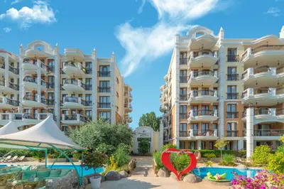 a view of two large apartment buildings with a swimming pool at Harmony Suites Grand Resort in Sunny Beach