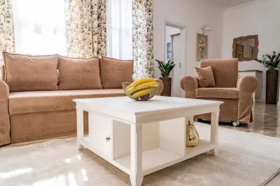 a living room with a couch and a white coffee table at KApartments in Varna City