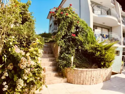 a stairway with flowers and plants in front of a building at Gardenia Suites in Sozopol