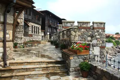 a stone alley with potted plants and a stone wall at Gardenia Suites in Sozopol