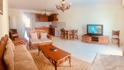 a living room with a couch and a tv at Gardenia Suites in Sozopol