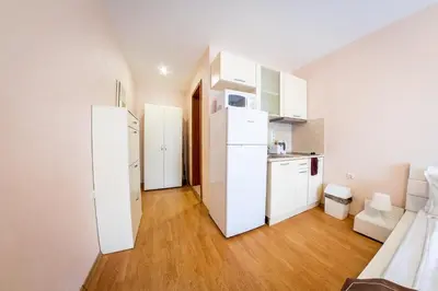 a kitchen with white appliances in a white apartment at Prestige Fort Beach - Full Board in Sveti Vlas