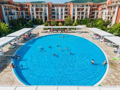 a group of people swimming in a large swimming pool at Prestige Fort Beach - Full Board in Sveti Vlas