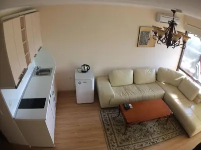 a living room with a couch and a table at Chateau Del Marina Penthouses in Nesebar