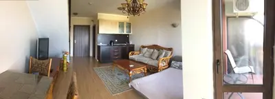 a living room with a couch and a table at Chateau Del Marina Penthouses in Nesebar