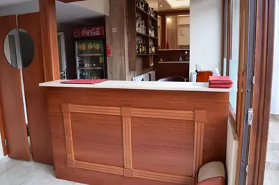 a bar with a wooden counter in a room at Family Hotel Chris in Sveti Vlas