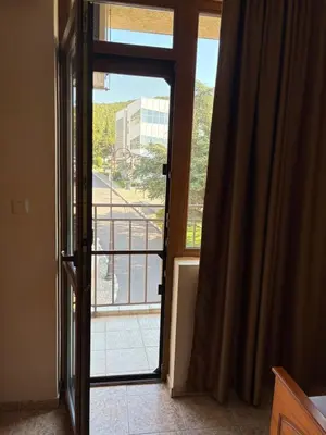 an open door to a balcony with a view at Family Hotel Chris in Sveti Vlas