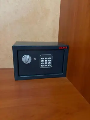 a black microwave oven sitting on top of a table at Family Hotel Chris in Sveti Vlas